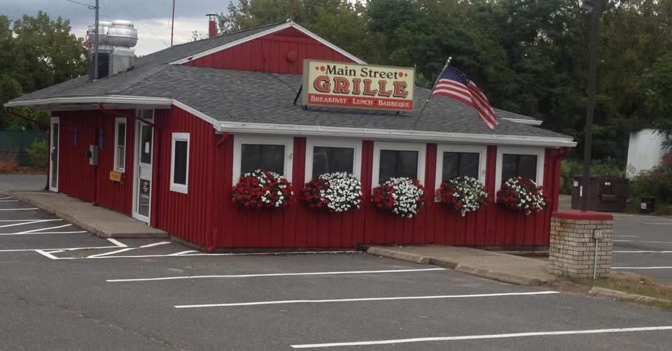The red exterior of Main Street Grille in Agawam with flower boxes