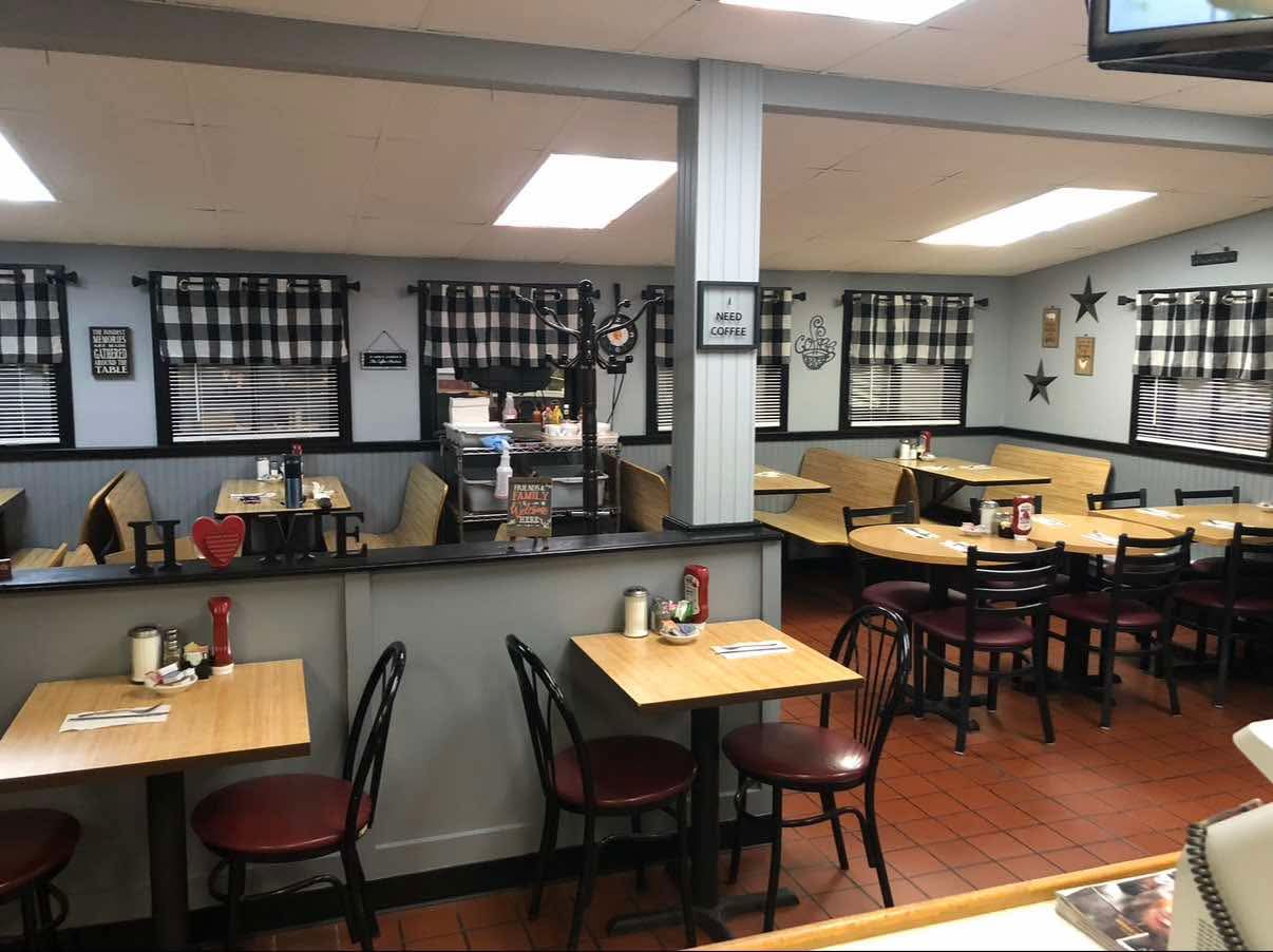 Dining room at Main Street Grille with cozy booths and checkered curtains