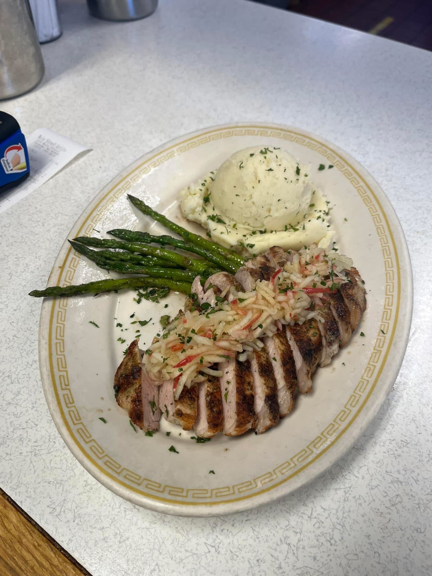 Sliced grilled chicken with mashed potatoes and asparagus