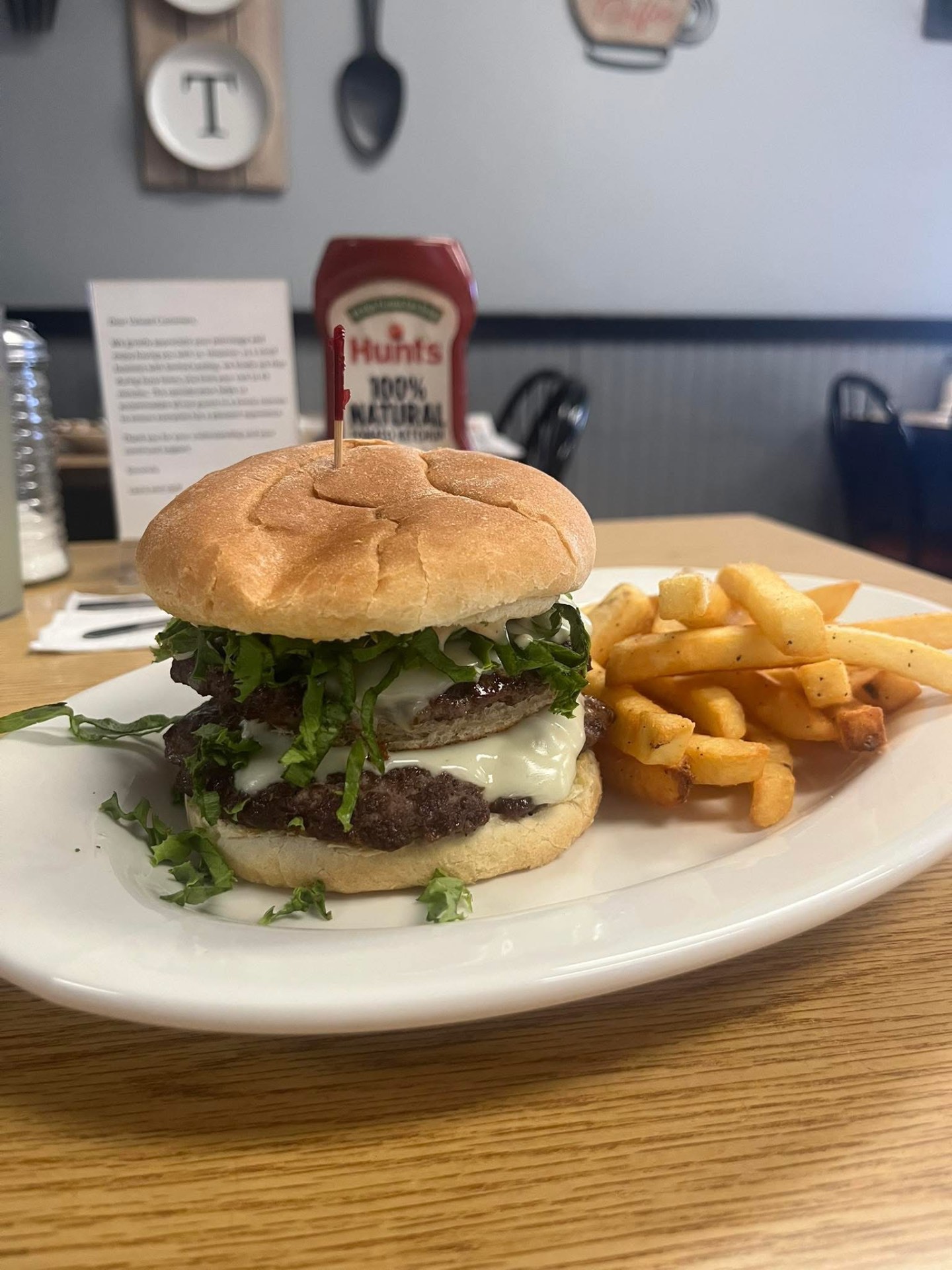 Double cheeseburger with lettuce and French fries